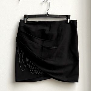 BEBE mini skirt  with chain decor